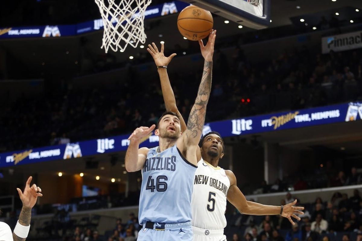 Feb 12, 2024; Memphis, Tennessee, USA; Memphis Grizzlies guard John Konchar (46) shoots as New Orleans Pelicans forward Herbert Jones (5) defends during the first half at FedExForum.