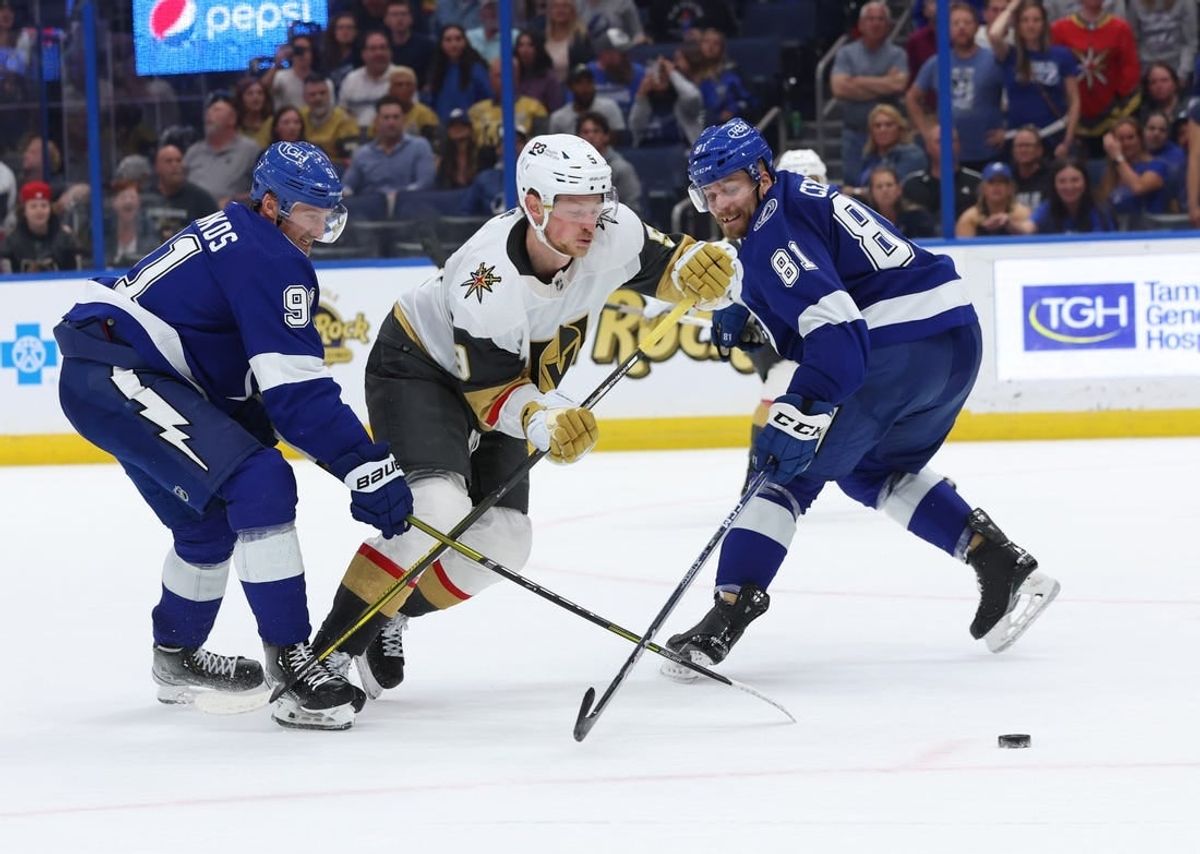 Mar 9, 2023; Tampa, Florida, USA; Tampa Bay Lightning center Steven Stamkos (91) and defenseman Erik Cernak (81) defend Vegas Golden Knights center Jack Eichel (9)  during overtime at Amalie Arena.
