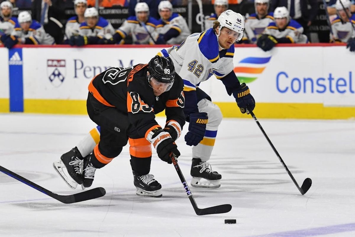 Mar 4, 2024; Philadelphia, Pennsylvania, USA; Philadelphia Flyers right wing Cam Atkinson (89) ands St. Louis Blues right wing Kasperi Kapanen (42) battle for the puck during the second period at Wells Fargo Center.