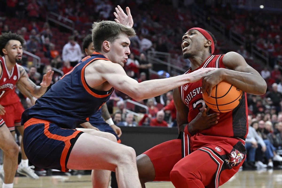 Jan 13, 2026; Louisville, Kentucky, USA;  Virginia Cavaliers center Johann Gruenloh (17) tries to steal the ball from Louisville Cardinals guard Ryan Conwell (3) during the second half at KFC Yum! Center. Virginia defeated Louisville 79-70. Mandatory Credit: Jamie Rhodes-Imagn Images