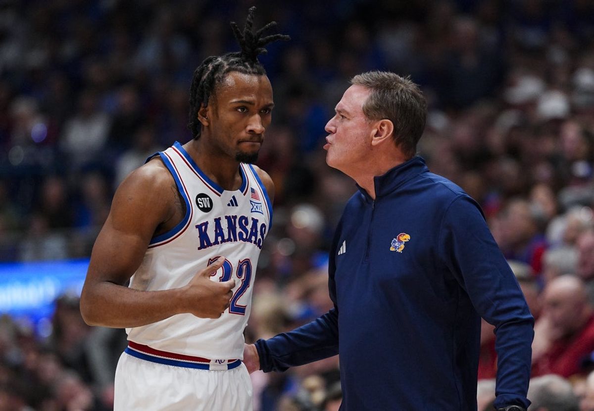 Jan 13, 2026; Lawrence, Kansas, USA; Kansas Jayhawks guard Darryn Peterson (22) talks to head coach Bill Self during the first half against the Iowa State Cyclones at Allen Fieldhouse. Mandatory Credit: Jay Biggerstaff-Imagn Images