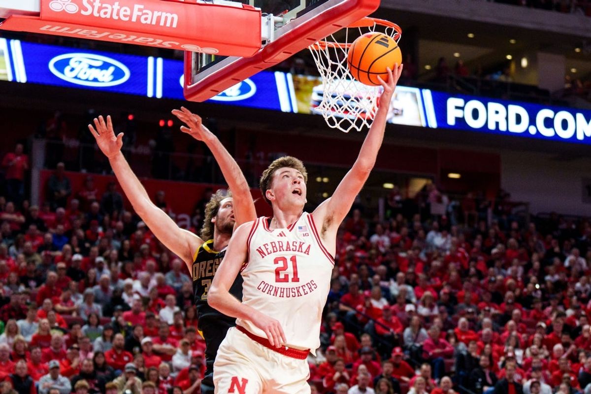 Jan 13, 2026; Lincoln, Nebraska, USA; Nebraska Cornhuskers forward Pryce Sandfort (21) shoots the ball against Oregon Ducks center Nate Bittle (32) during the first half at Pinnacle Bank Arena. Mandatory Credit: Dylan Widger-Imagn Images