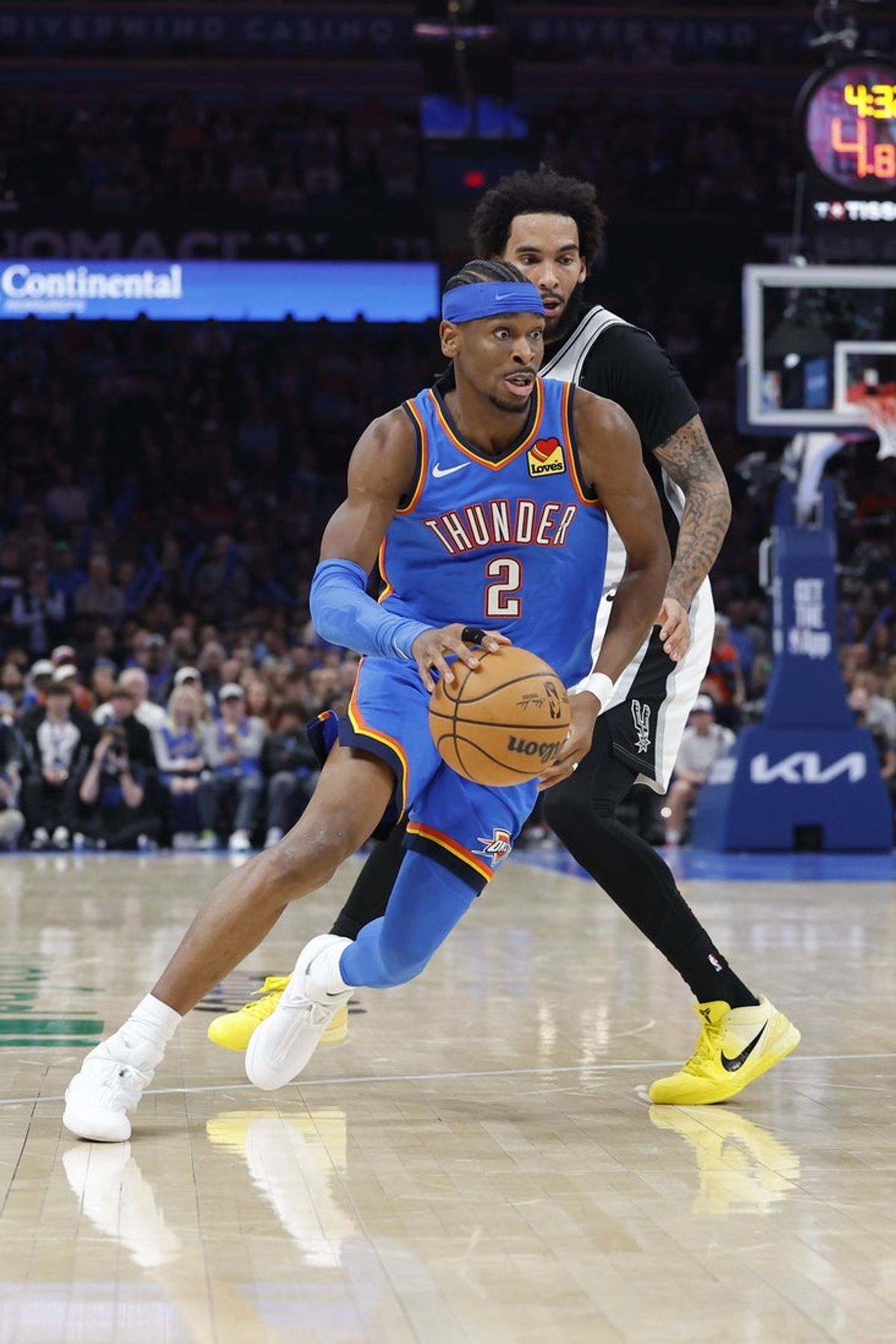 Jan 13, 2026; Oklahoma City, Oklahoma, USA; Oklahoma City Thunder guard Shai Gilgeous-Alexander (2) moves the ball around San Antonio Spurs forward Julian Champagnie (30) during the second half at Paycom Center. Mandatory Credit: Alonzo Adams-Imagn Images
