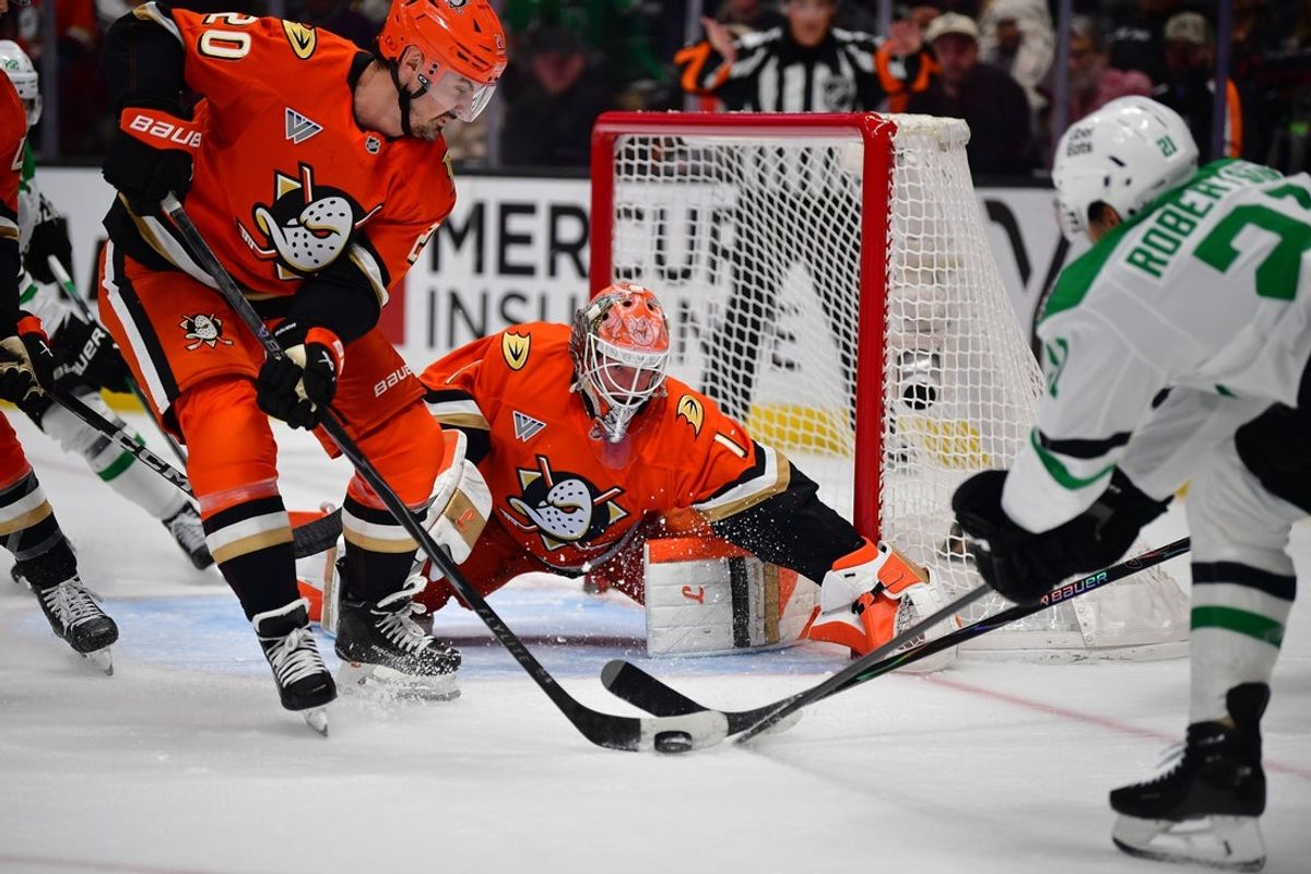 Jan 13, 2026; Anaheim, California, USA; Anaheim Ducks left wing Chris Kreider (20) helps goaltender Lukas Dostal (1) defend the goal against Dallas Stars left wing Jason Robertson (21)during the first period at Honda Center. Mandatory Credit: Gary A. Vasquez-Imagn Images