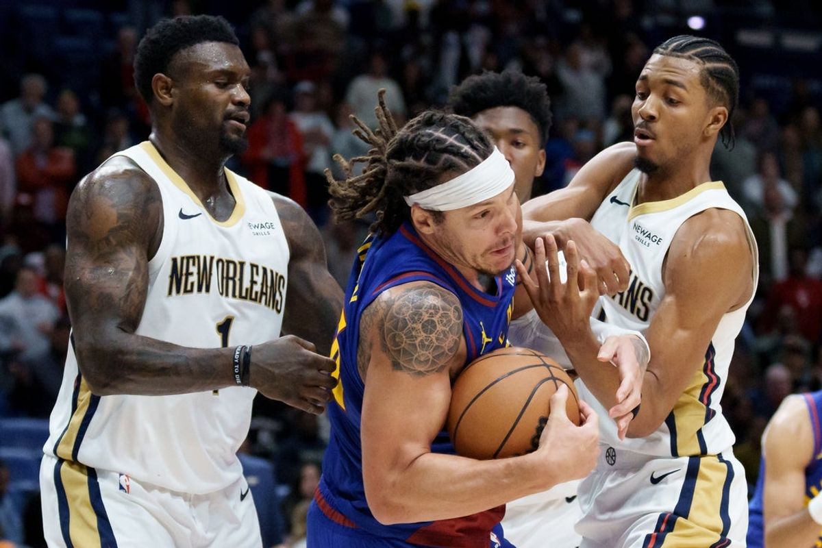 Jan 13, 2026; New Orleans, Louisiana, USA;  Denver Nuggets forward Aaron Gordon (32) grabs a rebound away from New Orleans Pelicans forward Zion Williamson (1) and forward Trey Murphy III (25) during the second half at Smoothie King Center. Mandatory Credit: Matthew Hinton-Imagn Images