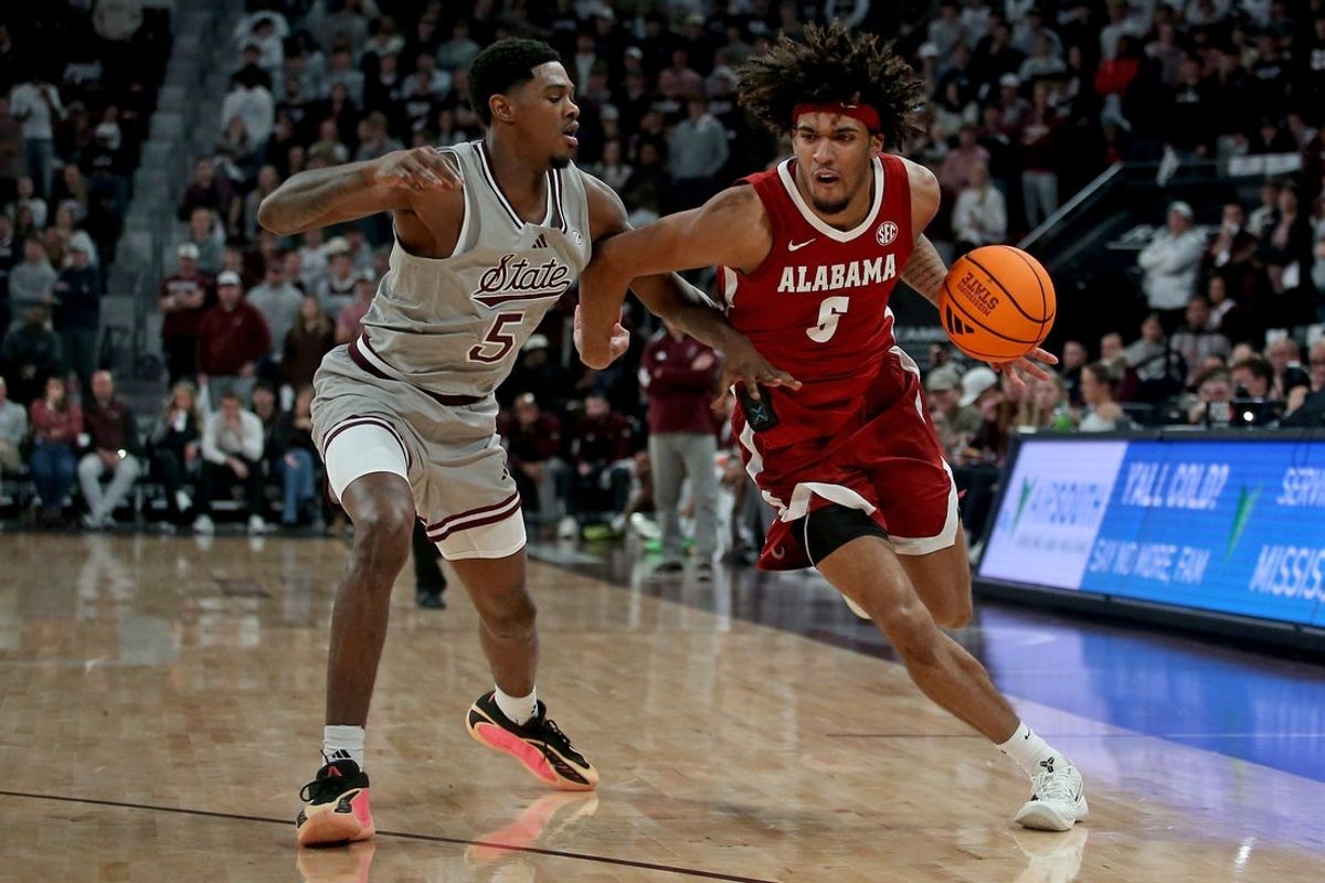 Jan 13, 2026; Starkville, Mississippi, USA; Alabama Crimson Tide forward Amari Allen (5) drives to the basket as Mississippi State Bulldogs guard Shawn Jones Jr. (5) defends during the second half at Humphrey Coliseum. Mandatory Credit: Petre Thomas-Imagn Images