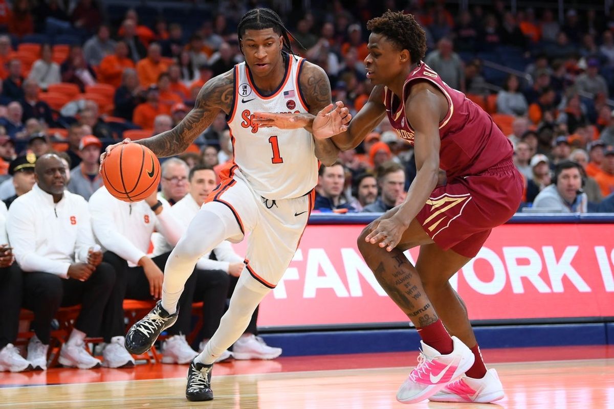 Jan 13, 2026; Syracuse, New York, USA; Syracuse Orange forward Donnie Freeman (1) drives against Florida State Seminoles guard Thomas Bassong (3) during the second half at the JMA Wireless Dome. Mandatory Credit: Rich Barnes-Imagn Images