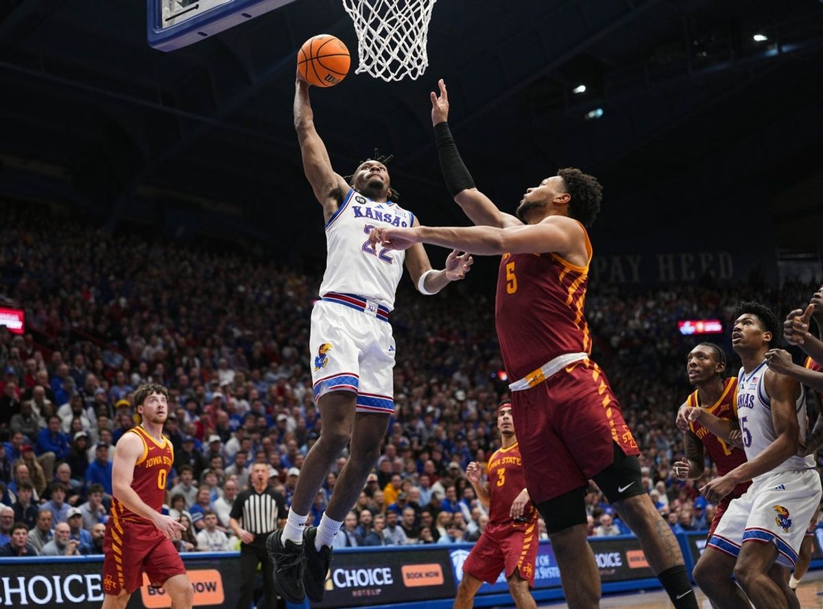 Jan 13, 2026; Lawrence, Kansas, USA; Kansas Jayhawks guard Darryn Peterson (22) attempts a dunk against Iowa State Cyclones forward Joshua Jefferson (5) during the second half at Allen Fieldhouse. Mandatory Credit: Jay Biggerstaff-Imagn Images