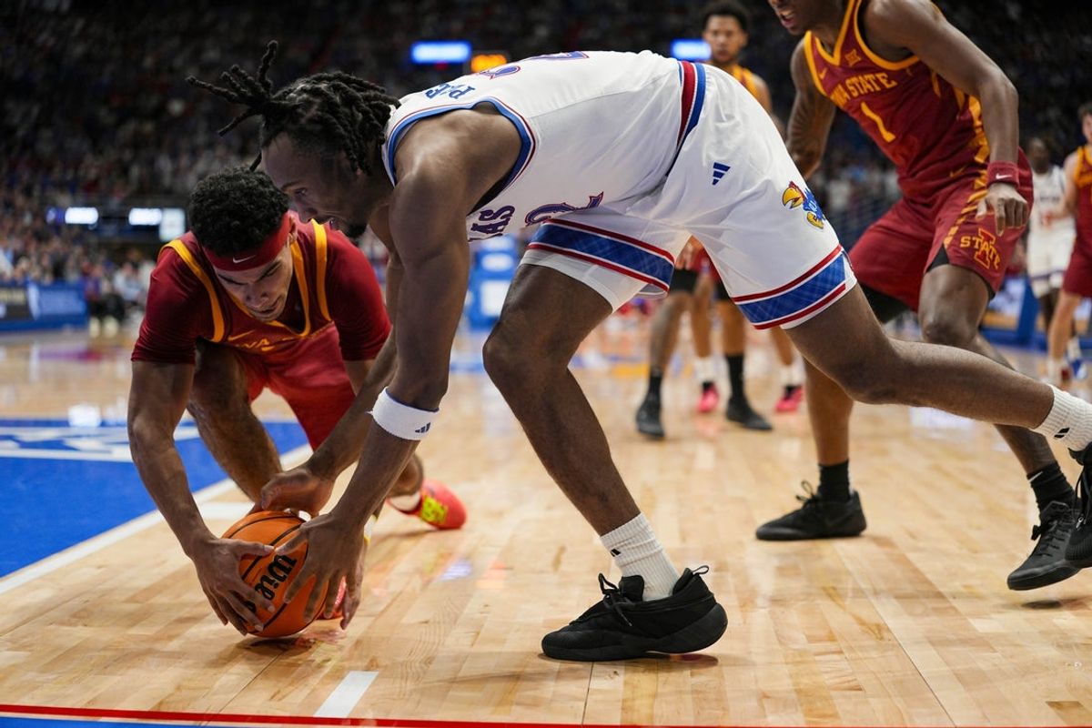 Jan 13, 2026; Lawrence, Kansas, USA; Kansas Jayhawks guard Darryn Peterson (22) and Iowa State Cyclones guard Tamin Lipsey (3) fight for a loose ball during the second half at Allen Fieldhouse. Mandatory Credit: Jay Biggerstaff-Imagn Images