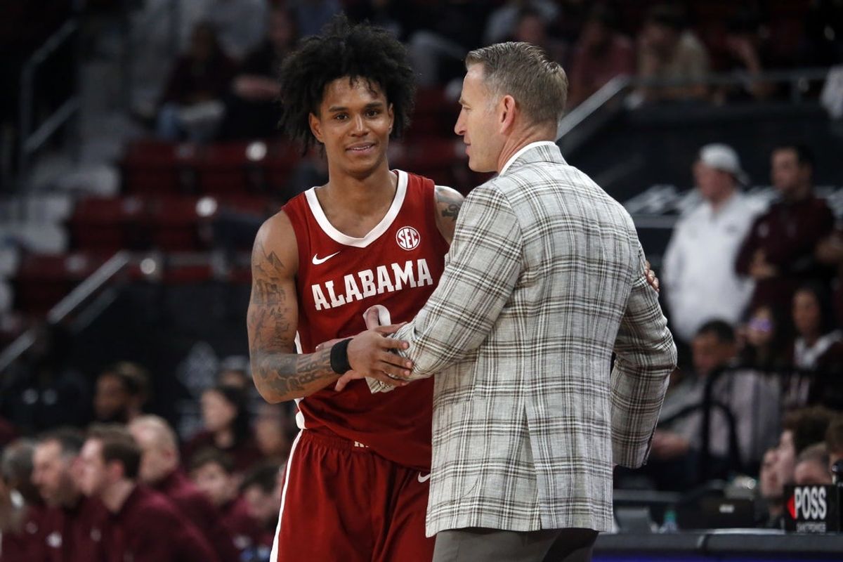 Jan 13, 2026; Starkville, Mississippi, USA; Alabama Crimson Tide guard Aden Holloway (2) embraces with head coach Nate Oats during the second half against the Mississippi State Bulldogs at Humphrey Coliseum. Mandatory Credit: Petre Thomas-Imagn Images