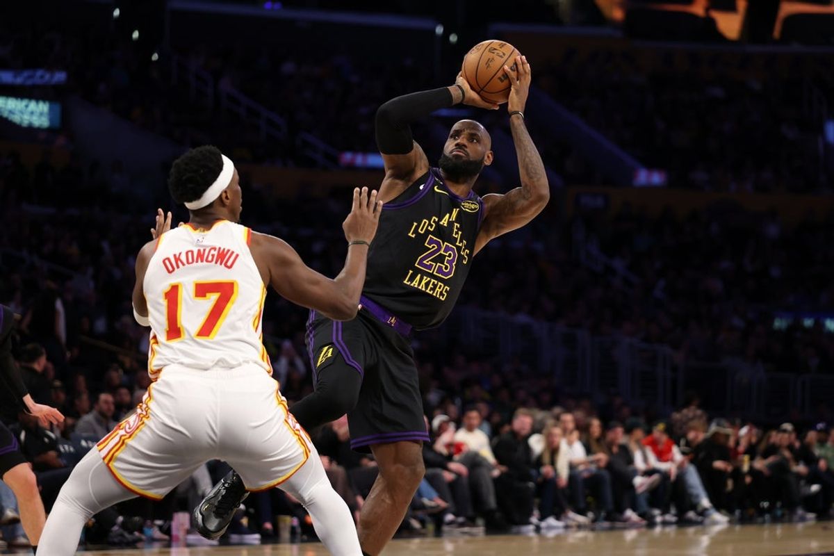 Jan 13, 2026; Los Angeles, California, USA;  Los Angeles Lakers forward LeBron James (23) shoots the ball against Atlanta Hawks forward Onyeka Okongwu (17) during the third quarter at Crypto.com Arena. Mandatory Credit: Kiyoshi Mio-Imagn Images