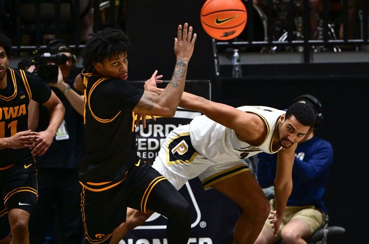 Jan 14, 2026; West Lafayette, Indiana, USA; Purdue Boilermakers forward Trey Kaufman-Renn (4) and Iowa Hawkeyes guard Tavion Banks (6) look at a loose ball during the first half at Mackey Arena. Mandatory Credit: Marc Lebryk-Imagn Images