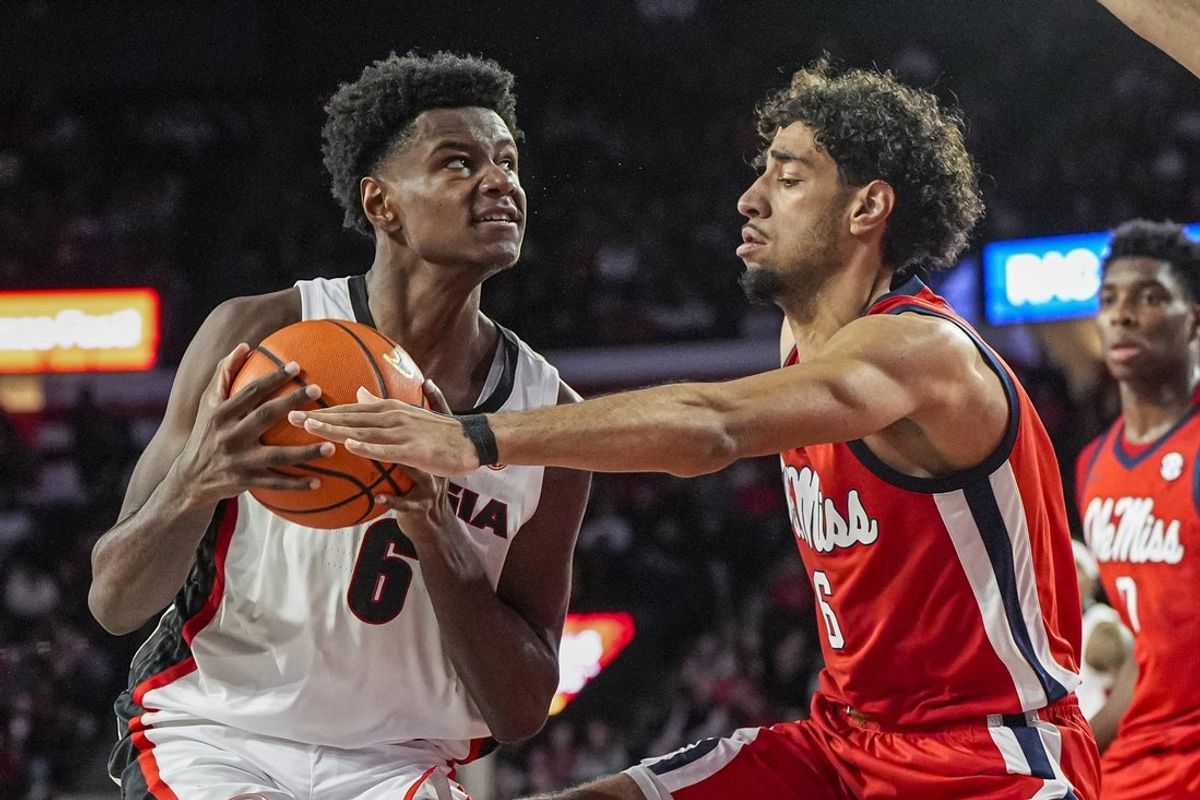 Jan 14, 2026; Athens, Georgia, USA; Georgia Bulldogs forward Kanon Catchings (6) drives against Mississippi Rebels guard Ilias Kamardine (6) during the first half at Stegeman Coliseum. Mandatory Credit: Dale Zanine-Imagn Images