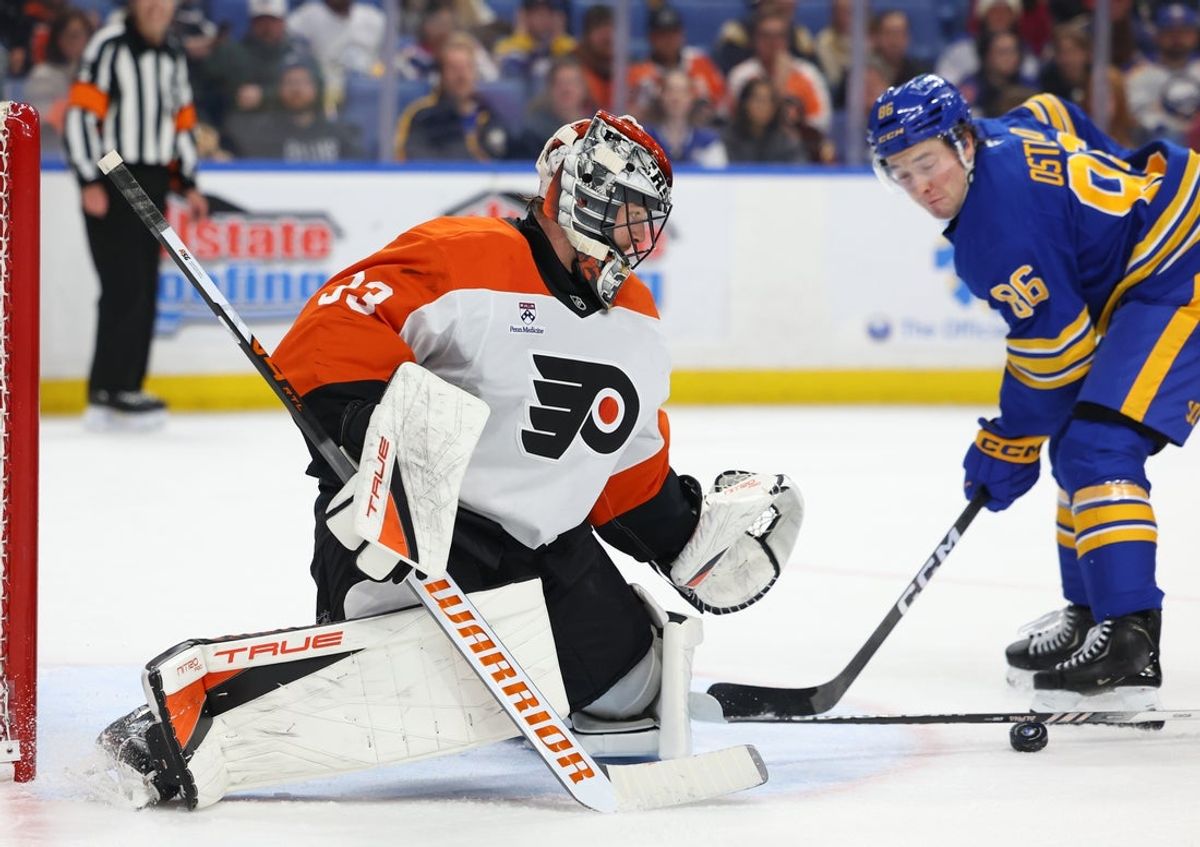 Jan 14, 2026; Buffalo, New York, USA;  Philadelphia Flyers goaltender Samuel Ersson (33) looks to cover up the puck during the second period against the Buffalo Sabres at KeyBank Center. Mandatory Credit: Timothy T. Ludwig-Imagn Images