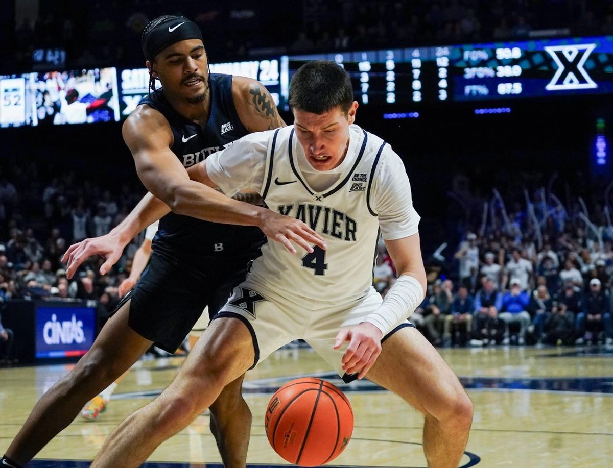 Butler Bulldogs guard Yame Butler (8) attempts to steal the ball from Xavier Musketeers forward Filip Borovicanin (4) in the second half of a NCAA men’s basketball game between the Xavier Musketeers and the Butler Bulldogs, Wednesday, Jan. 14, 2026, at Cintas Center in Cincinnati. Musketeers won 89-75.