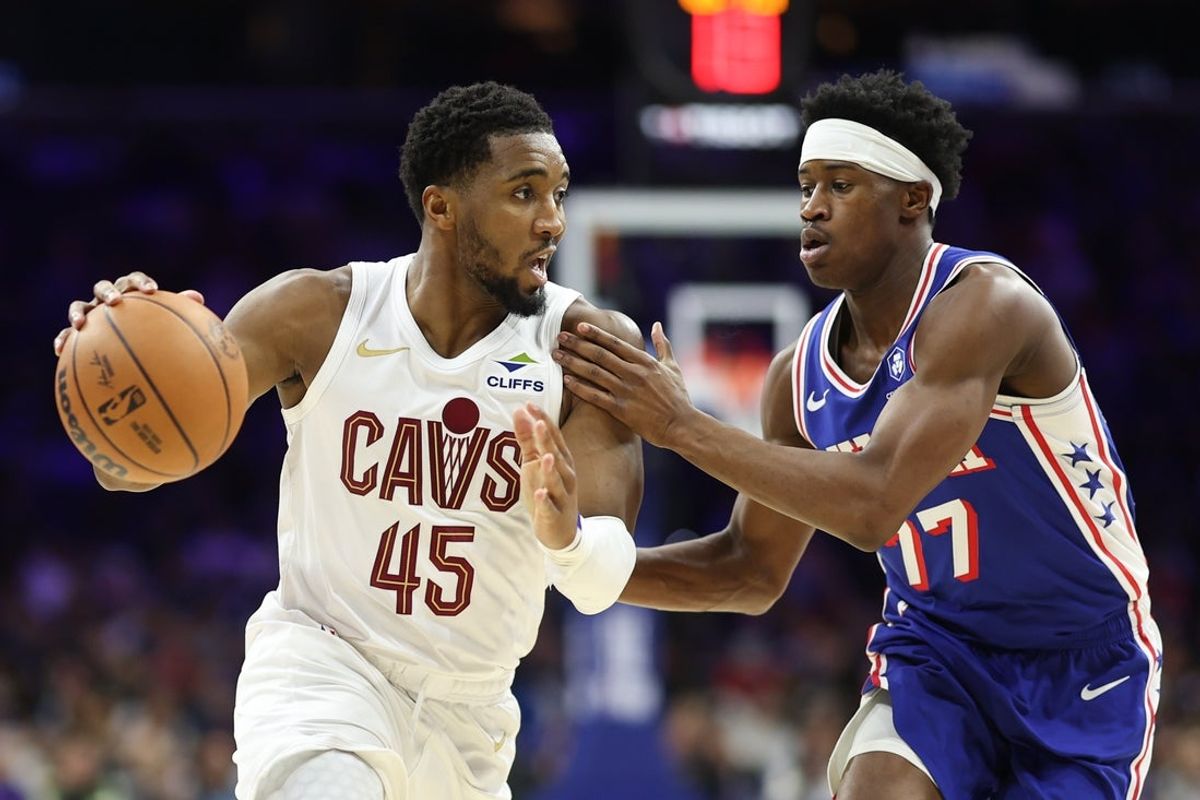 Jan 14, 2026; Philadelphia, Pennsylvania, USA; Cleveland Cavaliers guard Donovan Mitchell (45) drives against Philadelphia 76ers guard Vj Edgecombe (77) during the third quarter at Xfinity Mobile Arena. Mandatory Credit: Bill Streicher-Imagn Images