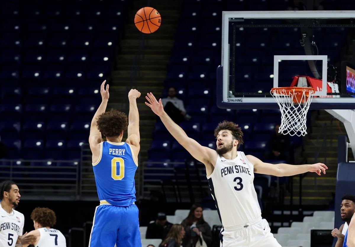 Jan 14, 2026; University Park, Pennsylvania, USA; Penn State Nittany Lions forward Ivan Juric (3) defends as UCLA Bruins guard Trent Perry (0) shoots the ball during the first half at Bryce Jordan Center. Mandatory Credit: Matthew O'Haren-Imagn Images