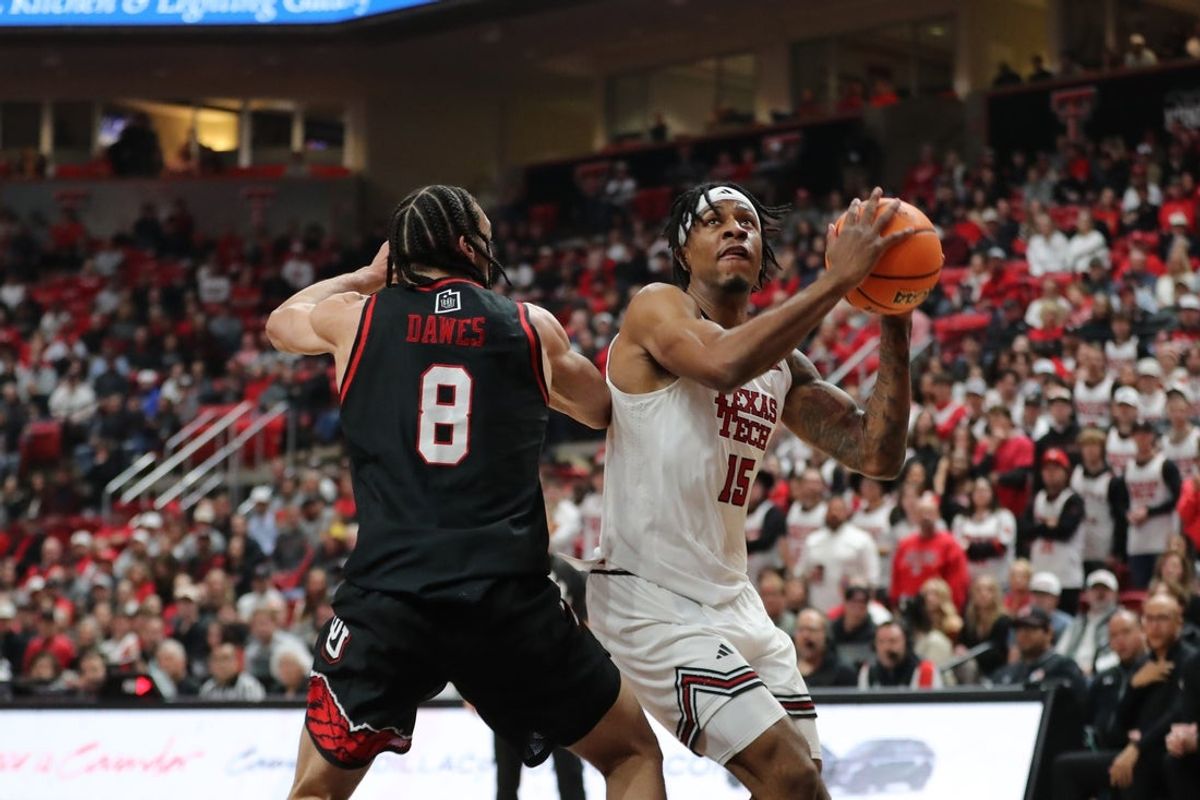 Jan 14, 2026; Lubbock, Texas, USA;  Texas Tech Red Raiders forward JT Toppin (15) shoots against Utah Utes forward Keanu Dawes (8) in the first half at United Supermarkets Arena. Mandatory Credit: Michael C. Johnson-Imagn Images