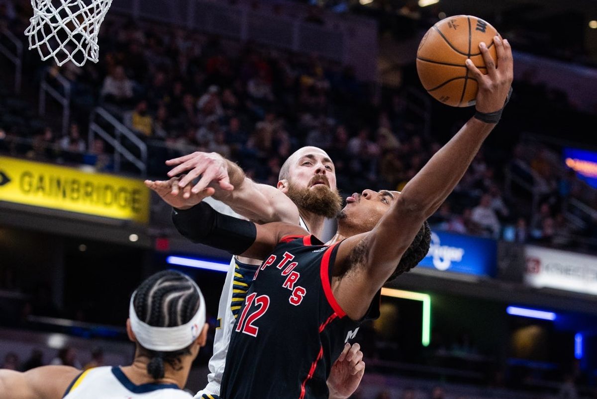 Jan 14, 2026; Indianapolis, Indiana, USA; Toronto Raptors forward Collin Murray-Boyles (12) shoots the ball while Indiana Pacers center Jay Huff (32) defends in the first half at Gainbridge Fieldhouse. Mandatory Credit: Trevor Ruszkowski-Imagn Images