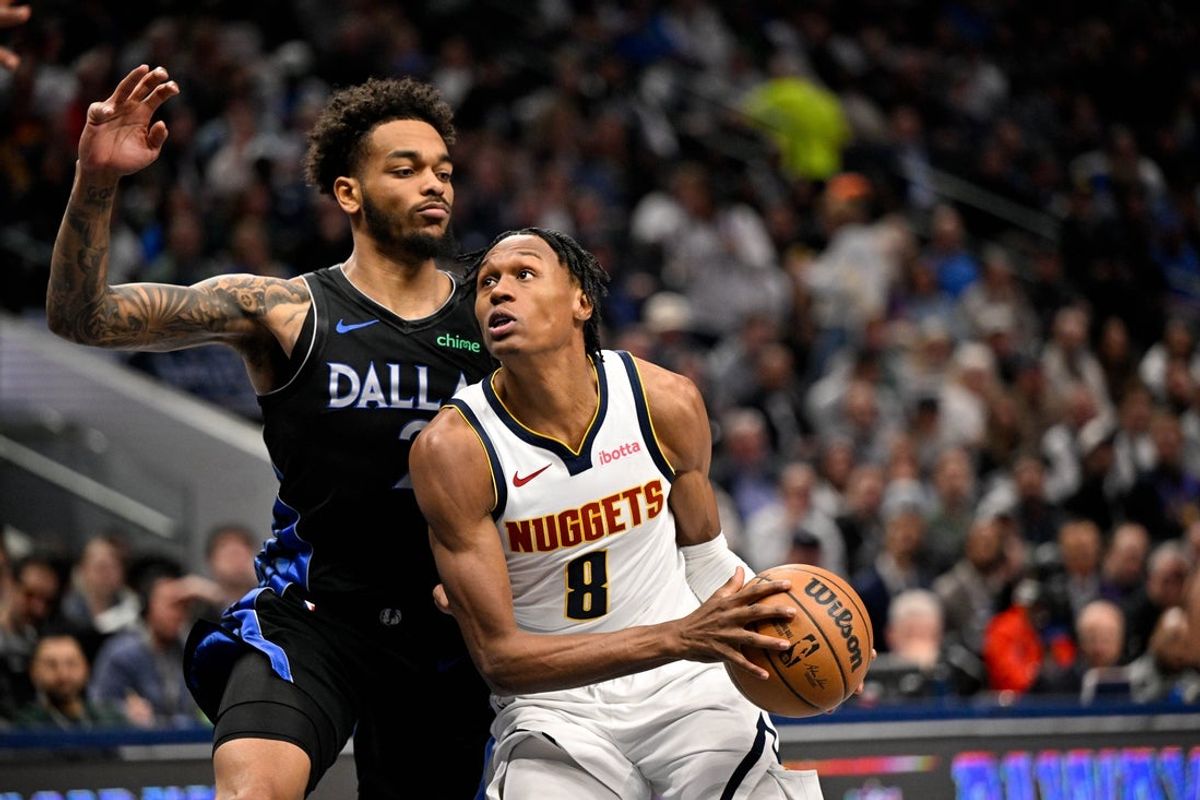 Jan 14, 2026; Dallas, Texas, USA; Denver Nuggets guard Peyton Watson (8) drives to the basket past Dallas Mavericks forward P.J. Washington (25) during the second quarter at the American Airlines Center. Mandatory Credit: Jerome Miron-Imagn Images