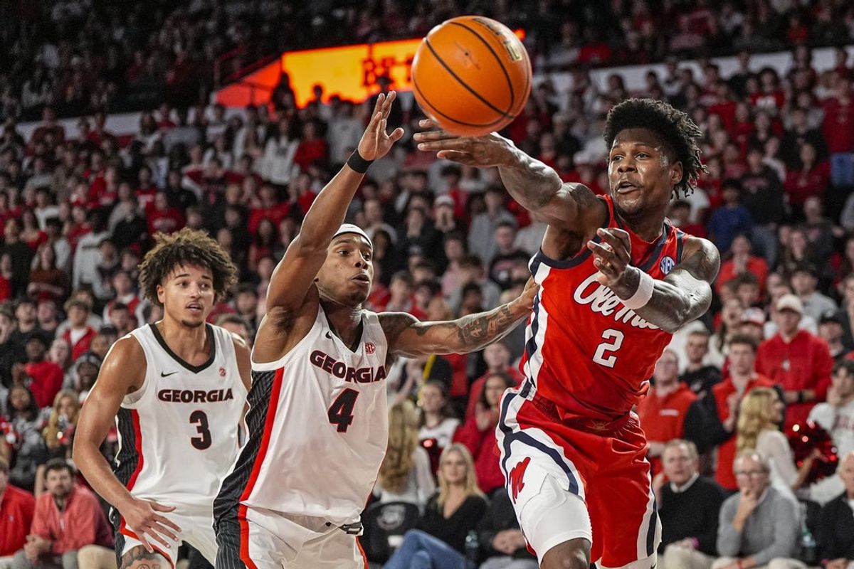 Jan 14, 2026; Athens, Georgia, USA; Mississippi Rebels guard AJ Storr (2) passes against Georgia Bulldogs guard Marcus Millender (4) during the second half at Stegeman Coliseum. Mandatory Credit: Dale Zanine-Imagn Images