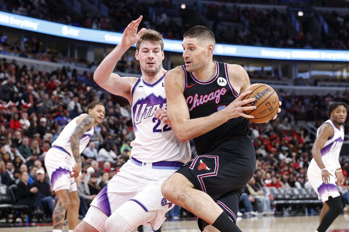 Jan 14, 2026; Chicago, Illinois, USA; Chicago Bulls center Nikola Vucevic (9) drives to the basket against Utah Jazz forward Kyle Filipowski (22) during the second half at United Center. Mandatory Credit: Kamil Krzaczynski-Imagn Images