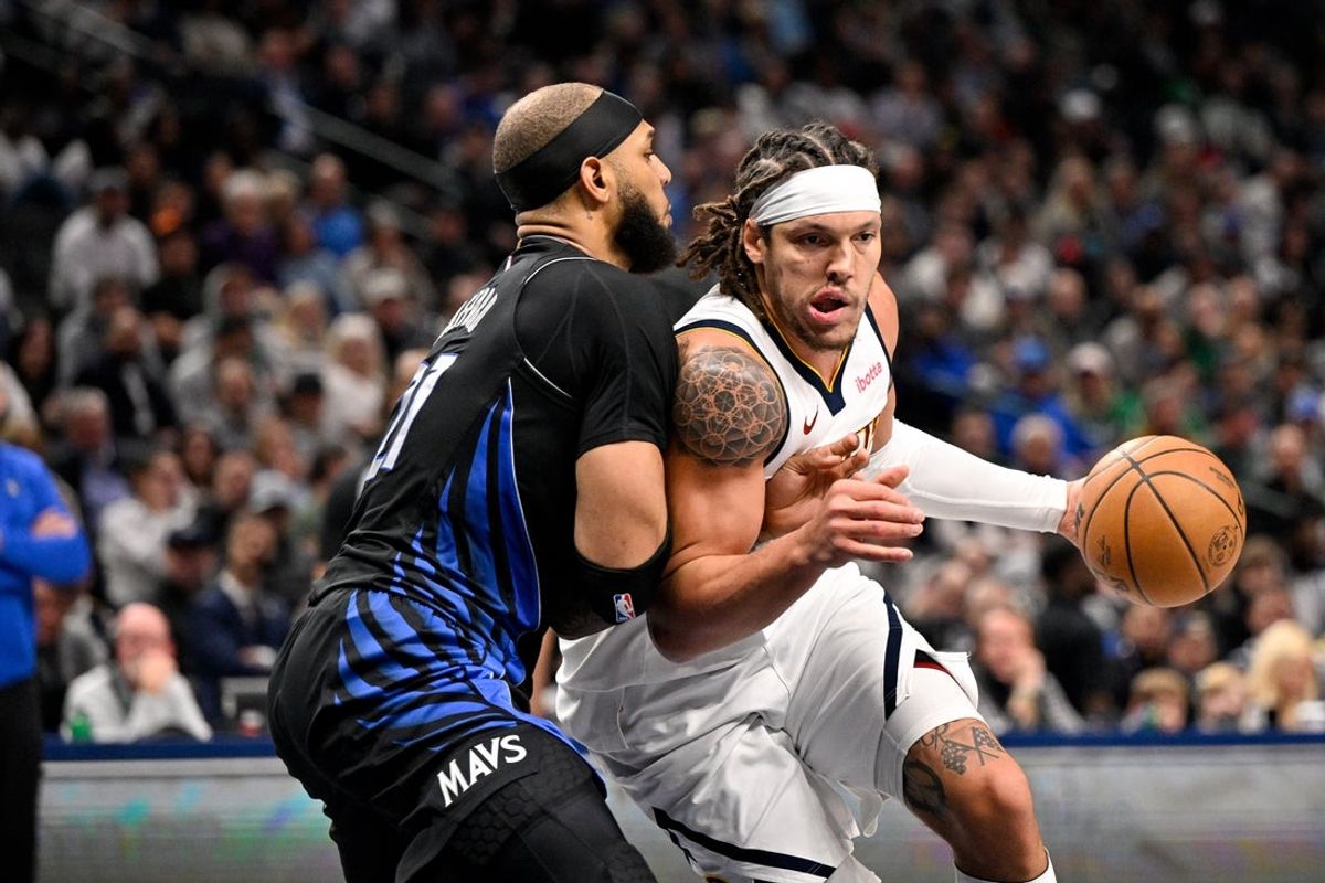 Jan 14, 2026; Dallas, Texas, USA; Denver Nuggets forward Aaron Gordon (32) brings the ball up court past Dallas Mavericks forward Daniel Gafford (21) during the second quarter at the American Airlines Center. Mandatory Credit: Jerome Miron-Imagn Images