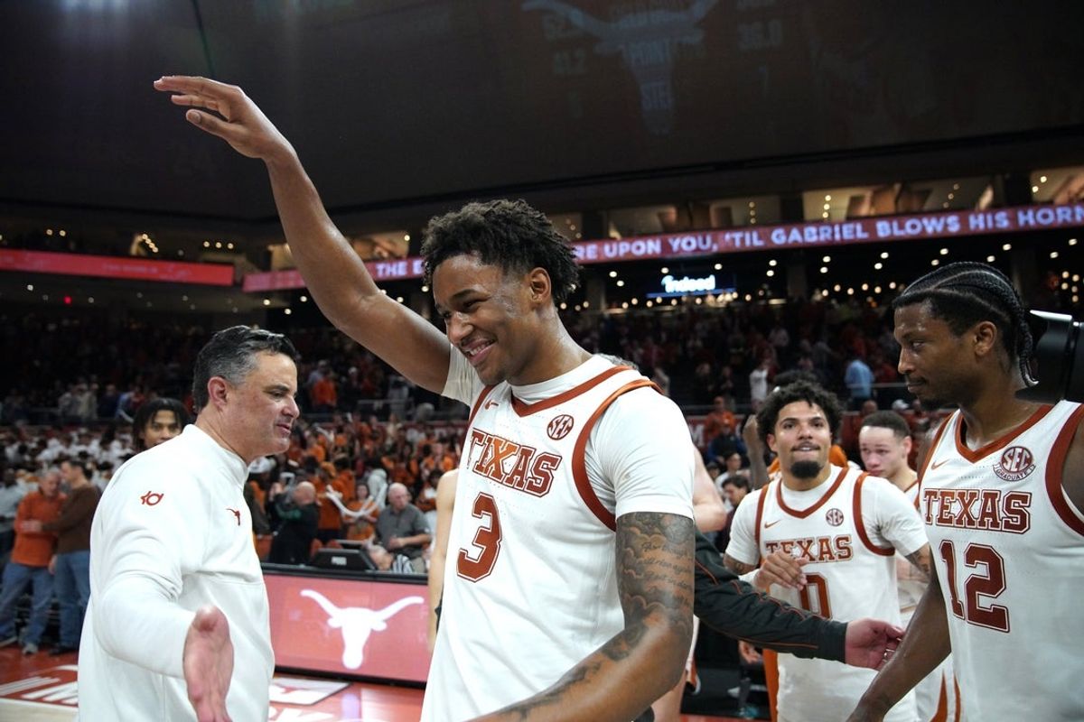 Jan 14, 2026; Austin, Texas, USA; Texas Longhorns guard Dailyn Swain (3) and head coach Sean Miller celebrate a win against the Vanderbilt Commodores after the game at Moody Center. Mandatory Credit: Dustin Safranek-Imagn Images