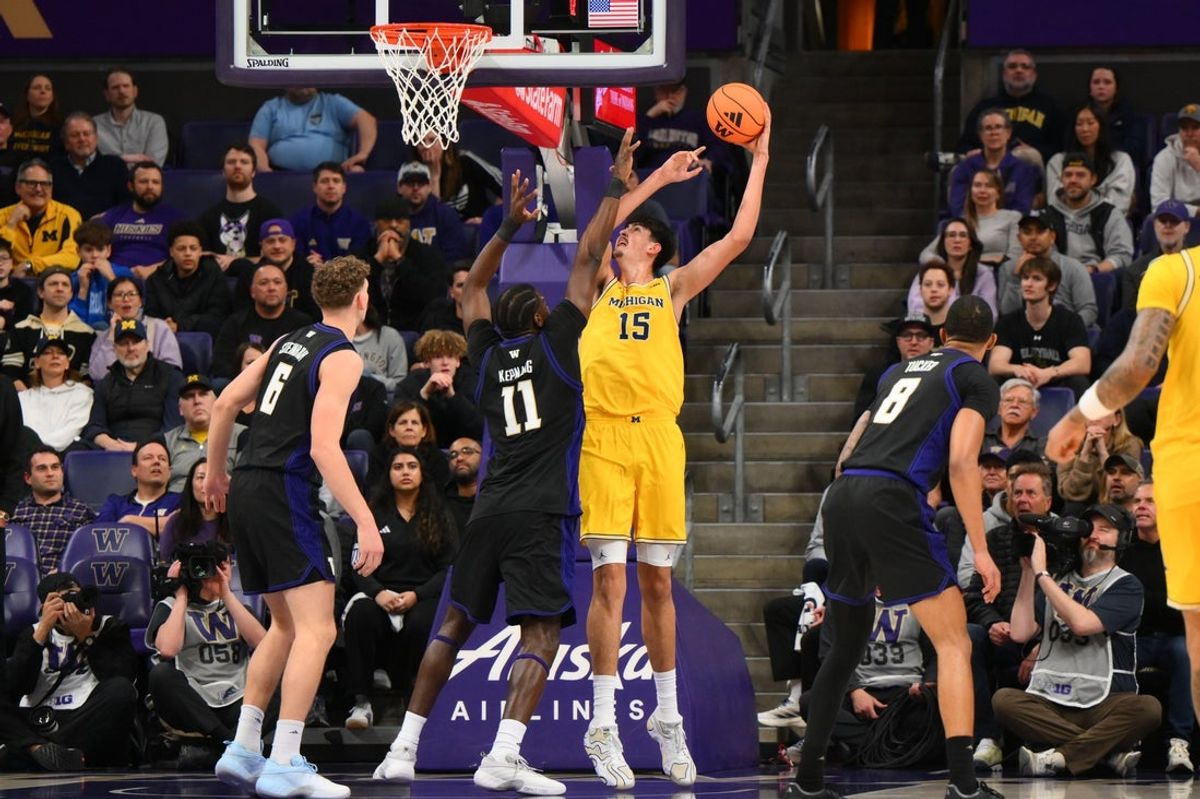 Jan 14, 2026; Seattle, Washington, USA; Michigan Wolverines center Aday Mara (15) shoots the ball over Washington Huskies center Franck Kepnang (11) during the first half at Alaska Airlines Arena at Hec Edmundson Pavilion. Mandatory Credit: Steven Bisig-Imagn Images