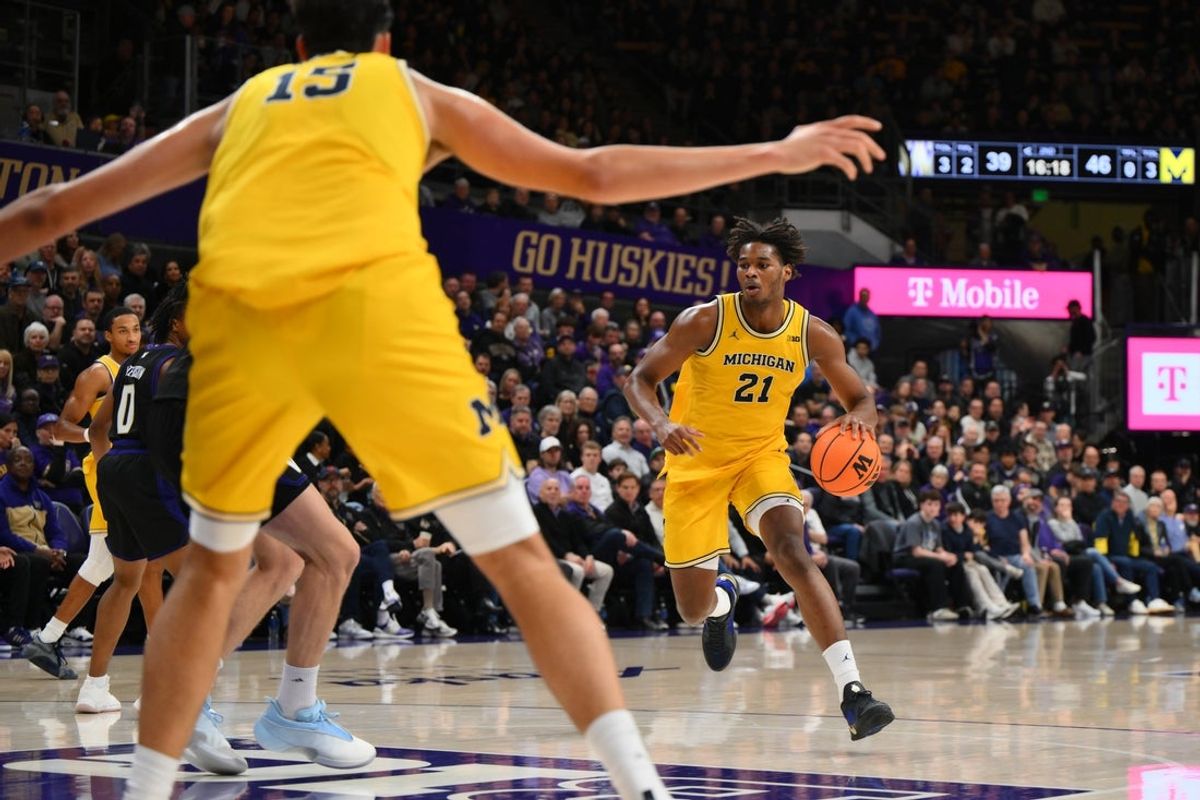 Jan 14, 2026; Seattle, Washington, USA; Michigan Wolverines forward Morez Johnson Jr. (21) dribbles towards the basket during the second half against the Washington Huskies at Alaska Airlines Arena at Hec Edmundson Pavilion. Mandatory Credit: Steven Bisig-Imagn Images