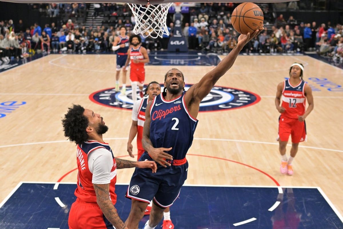 Jan 14, 2026; Inglewood, California, USA;  Los Angeles Clippers forward Kawhi Leonard (2) drives to the basket past Washington Wizards forward Justin Champagnie (9) in the first half at Intuit Dome. Mandatory Credit: Jayne Kamin-Oncea-Imagn Imagesd