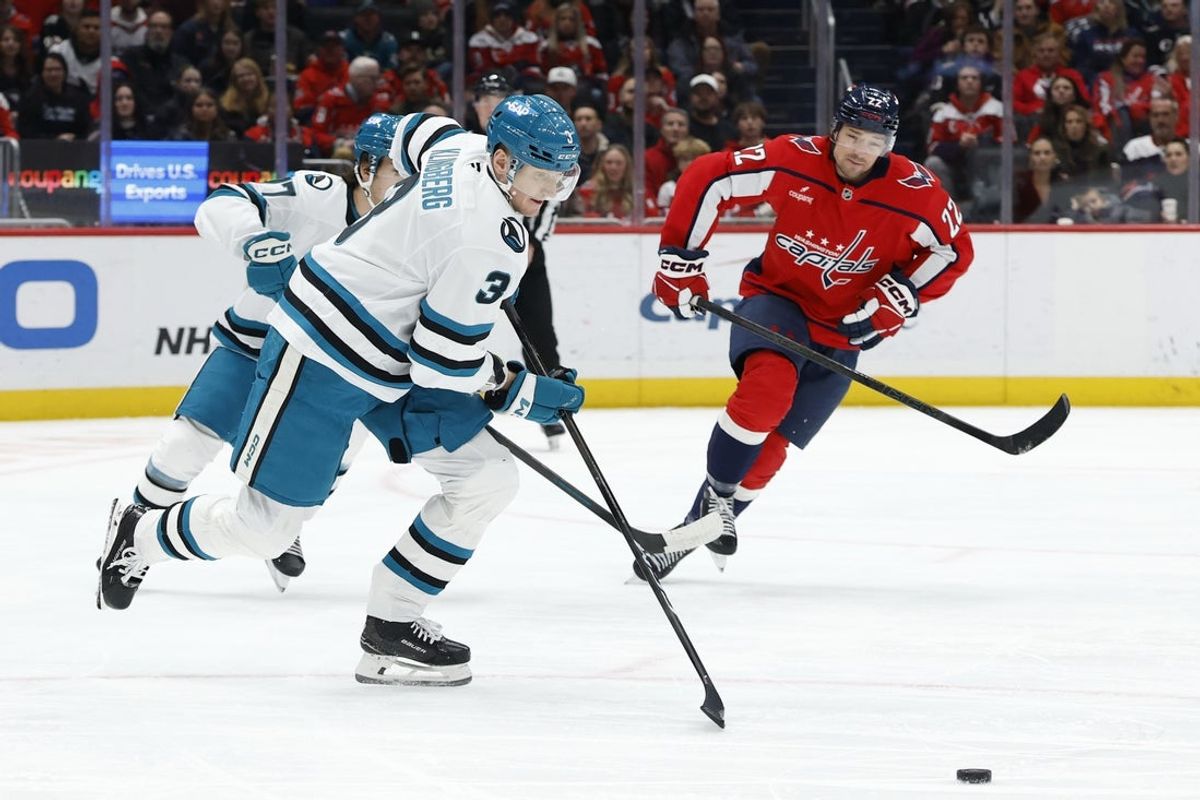 Jan 15, 2026; Washington, District of Columbia, USA; San Jose Sharks defenseman John Klingberg (3) skates with the puck as Washington Capitals right wing Brandon Duhaime (22) chases during the first period at Capital One Arena. Mandatory Credit: Geoff Burke-Imagn Images