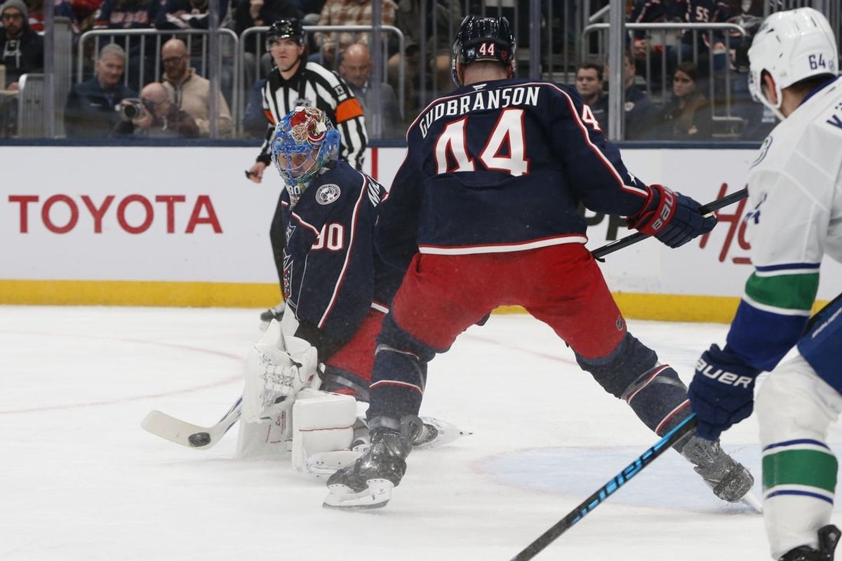 Jan 15, 2026; Columbus, Ohio, USA; Columbus Blue Jackets goalie Elvis Merzlikins (90) makes a stick save against the Vancouver Canucks during the first period at Nationwide Arena. Mandatory Credit: Russell LaBounty-Imagn Images