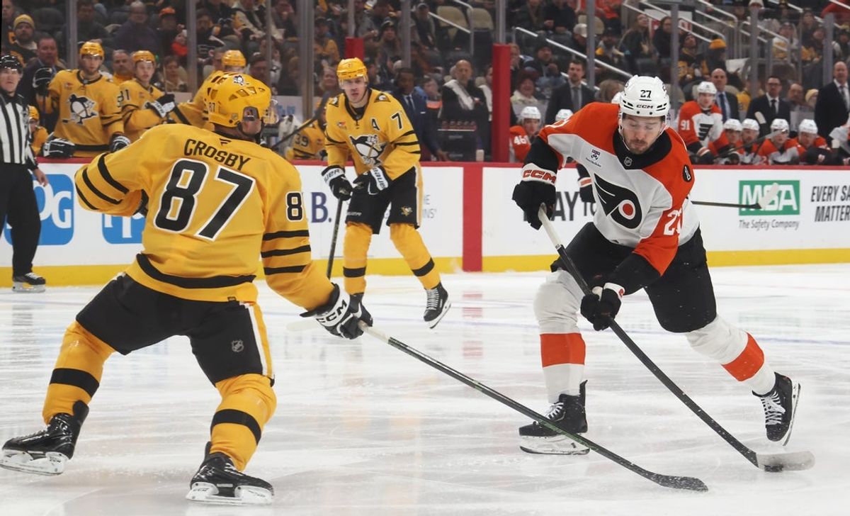 Jan 15, 2026; Pittsburgh, Pennsylvania, USA;  Philadelphia Flyers left wing Noah Cates (27) shoots the puck as Pittsburgh Penguins center Sidney Crosby (87) defends during the first period at PPG Paints Arena. Mandatory Credit: Charles LeClaire-Imagn Images