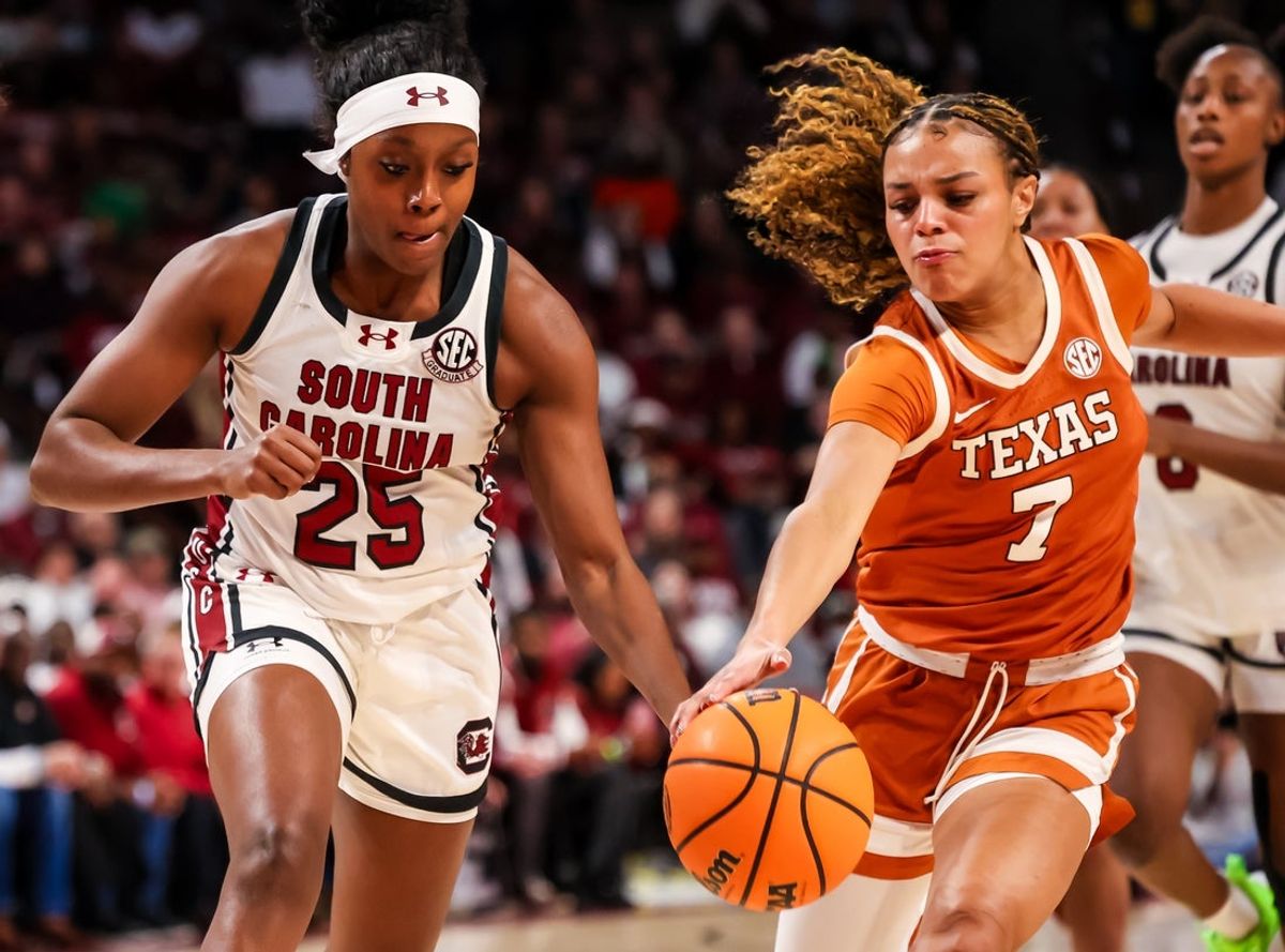 Jan 15, 2026; Columbia, South Carolina, USA; Texas Longhorns guard Jordan Lee (7) steals the ball from South Carolina Gamecocks guard Raven Johnson (25) in the first half at Colonial Life Arena. Mandatory Credit: Jeff Blake-Imagn Images
