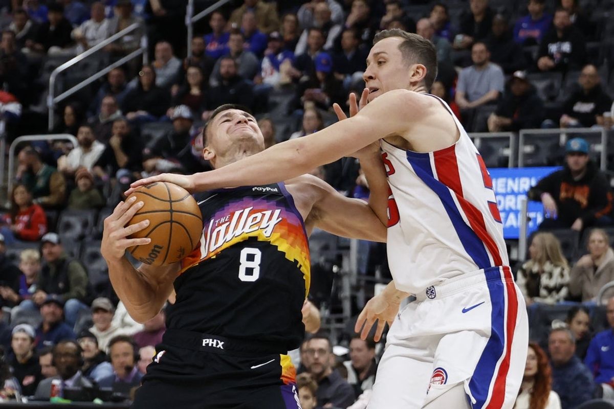 Jan 15, 2026; Detroit, Michigan, USA;  Phoenix Suns guard Grayson Allen (8) is defended by Detroit Pistons forward Duncan Robinson (55) in the first half at Little Caesars Arena. Mandatory Credit: Rick Osentoski-Imagn Images
