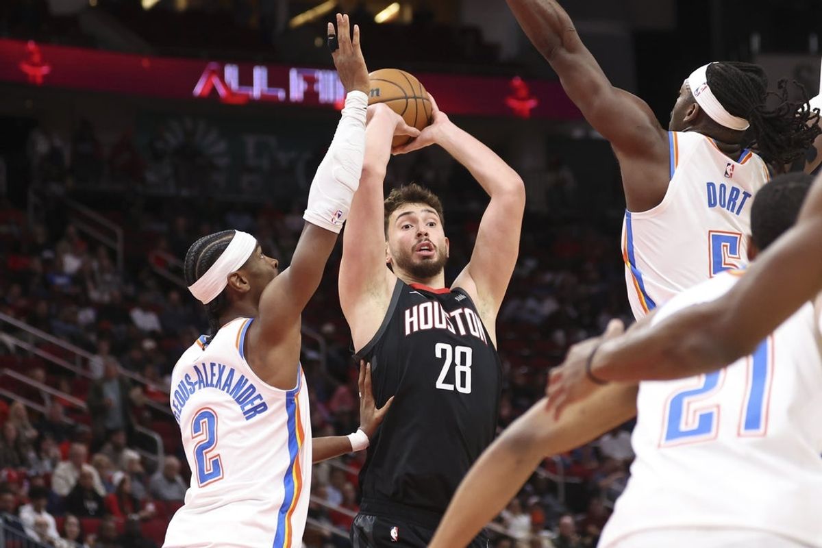 Jan 15, 2026; Houston, Texas, USA; Houston Rockets center Alperen Sengun (28) looks to pass the ball as Oklahoma City Thunder guard Shai Gilgeous-Alexander (2) defends during the first quarter at Toyota Center. Mandatory Credit: Troy Taormina-Imagn Images