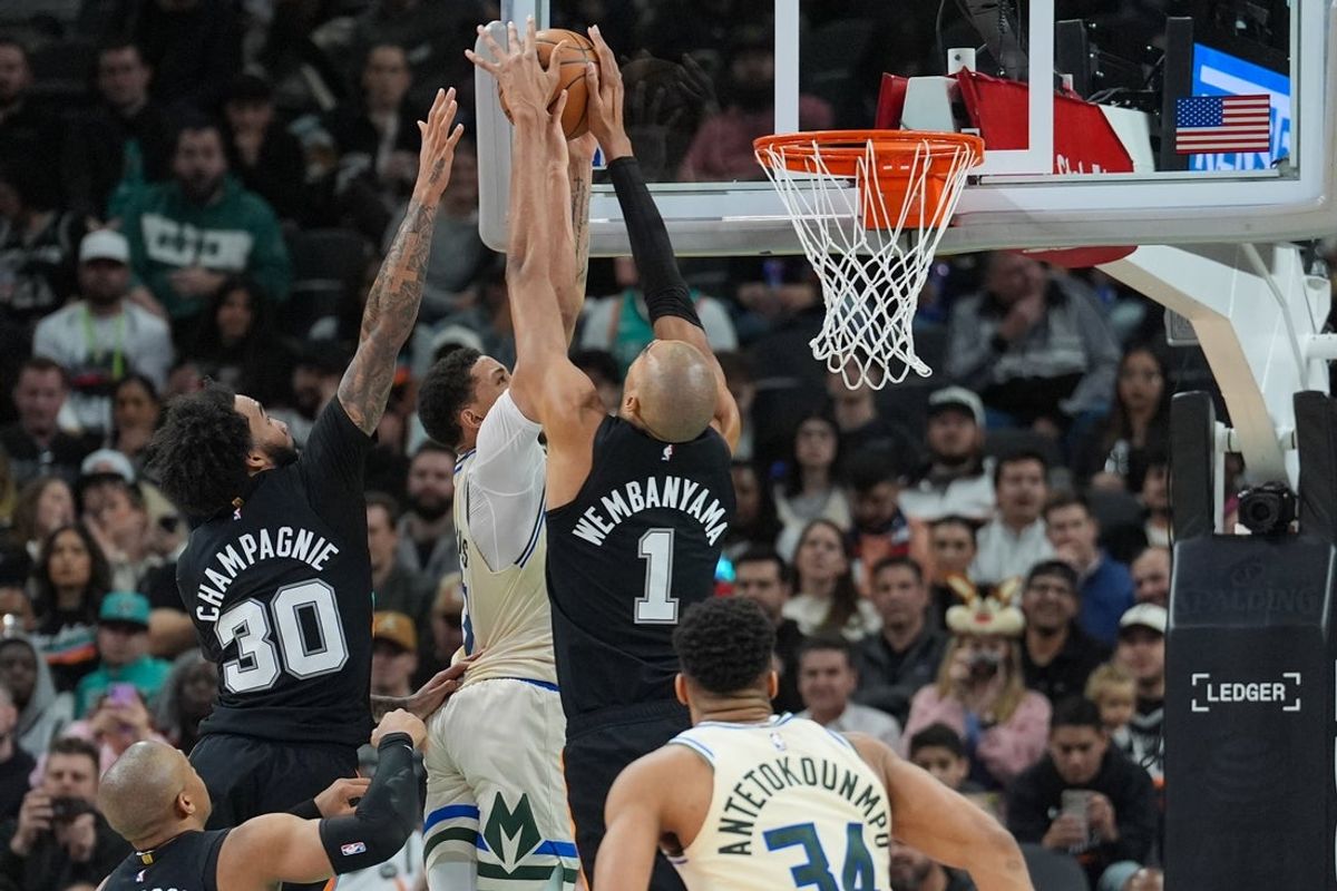Jan 15, 2026; San Antonio, Texas, USA;  San Antonio Spurs forward/center Victor Wembanyama (1) blocks a shot by Milwaukee Bucks guard Ryan Rollins (13) in the first half at Frost Bank Center. Mandatory Credit: Daniel Dunn-Imagn Images