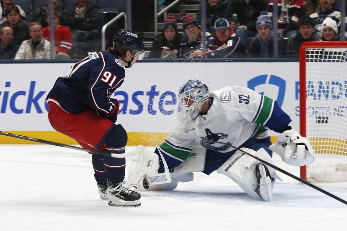 Jan 15, 2026; Columbus, Ohio, USA; Columbus Blue Jackets center Kent Johnson (91) scores a goal against Vancouver Canucks goalie Kevin Lankinen (32) during the third period at Nationwide Arena. Mandatory Credit: Russell LaBounty-Imagn Images