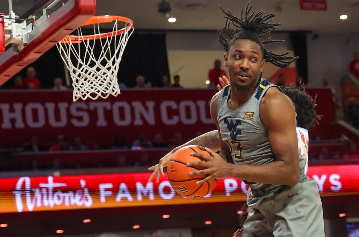 Jan 13, 2026; Houston, Texas, USA; West Virginia Mountaineers guard Chance Moore (13) grabs a defensive rebound against Houston Cougars guard Ramon Walker Jr. (3) in the second half  at Fertitta Center. Mandatory Credit: Thomas Shea-Imagn Images