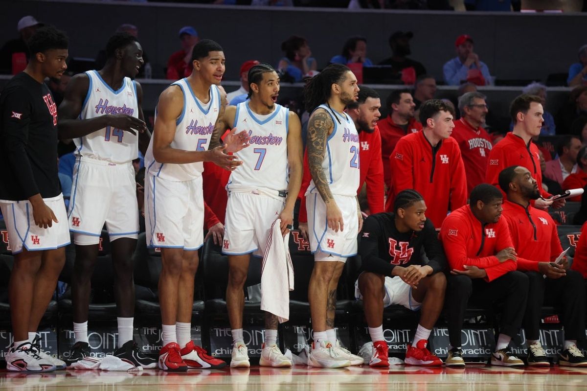 Jan 13, 2026; Houston, Texas, USA; Houston Cougars forward Kalifa Sakho (14) center Chris Cenac Jr. (5)  guard Milos Uzan (7) and  guard Emanuel Sharp (21) react while they watch their teammates play against the West Virginia Mountaineers in the second half  at Fertitta Center. Mandatory Credit: Thomas Shea-Imagn Images