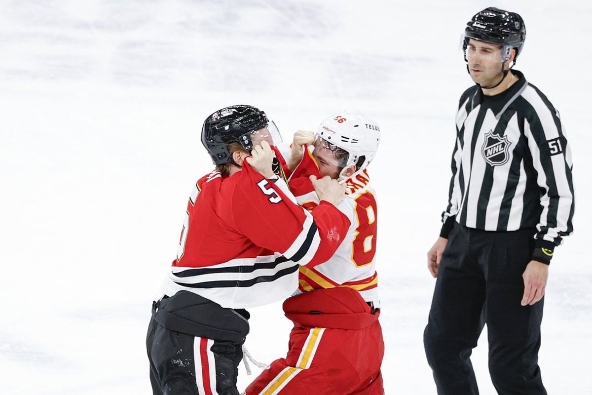 Jan 15, 2026; Chicago, Illinois, USA; Chicago Blackhawks defenseman Connor Murphy (5) fights with Calgary Flames left wing Joel Farabee (86) during the second period at United Center. Mandatory Credit: Kamil Krzaczynski-Imagn Images