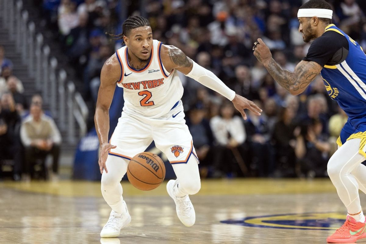 Jan 15, 2026; San Francisco, California, USA; New York Knicks guard Miles McBride (2) drives past Golden State Warriors guard Gary Payton II (0) during the second quarter at Chase Center. Mandatory Credit: D. Ross Cameron-Imagn Images