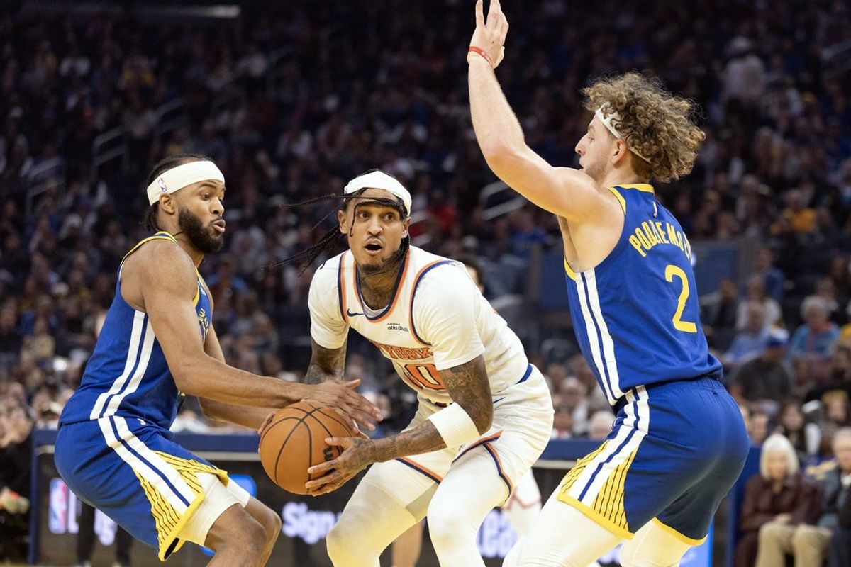 Jan 15, 2026; San Francisco, California, USA; Golden State Warriors guards Moses Moody (left) and Brandin Podziemski (2) defend against New York Knicks guard Jordan Clarkson (00) during the second quarter at Chase Center. Mandatory Credit: D. Ross Cameron-Imagn Images