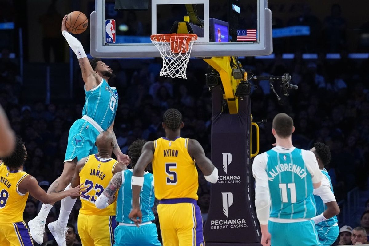 Jan 15, 2026; Los Angeles, California, USA; Charlotte Hornets forward Miles Bridges (0) dunks the ball against the Los Angeles Lakers in the first half at Crypto.com Arena. Mandatory Credit: Kirby Lee-Imagn Images