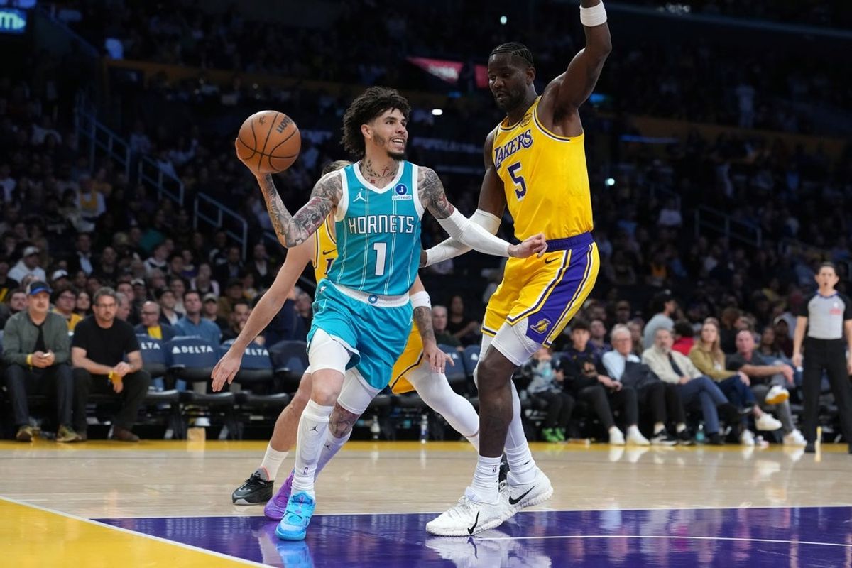 Jan 15, 2026; Los Angeles, California, USA; Charlotte Hornets guard LaMelo Ball (1) passes the ball against Los Angeles Lakers center Deandre Ayton (5) in the second half at Crypto.com Arena. Mandatory Credit: Kirby Lee-Imagn Images
