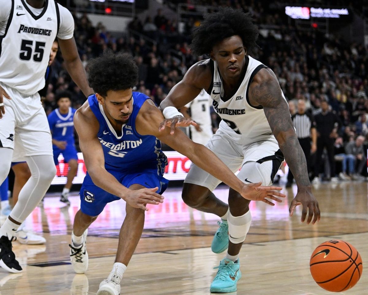 Jan 16, 2026; Providence, Rhode Island, USA; Creighton Bluejays guard Nik Graves (5) and Providence Friars guard Jaylin Sellers (2) reach for the ball during the first half at Amica Mutual Pavilion. Mandatory Credit: Eric Canha-Imagn Images