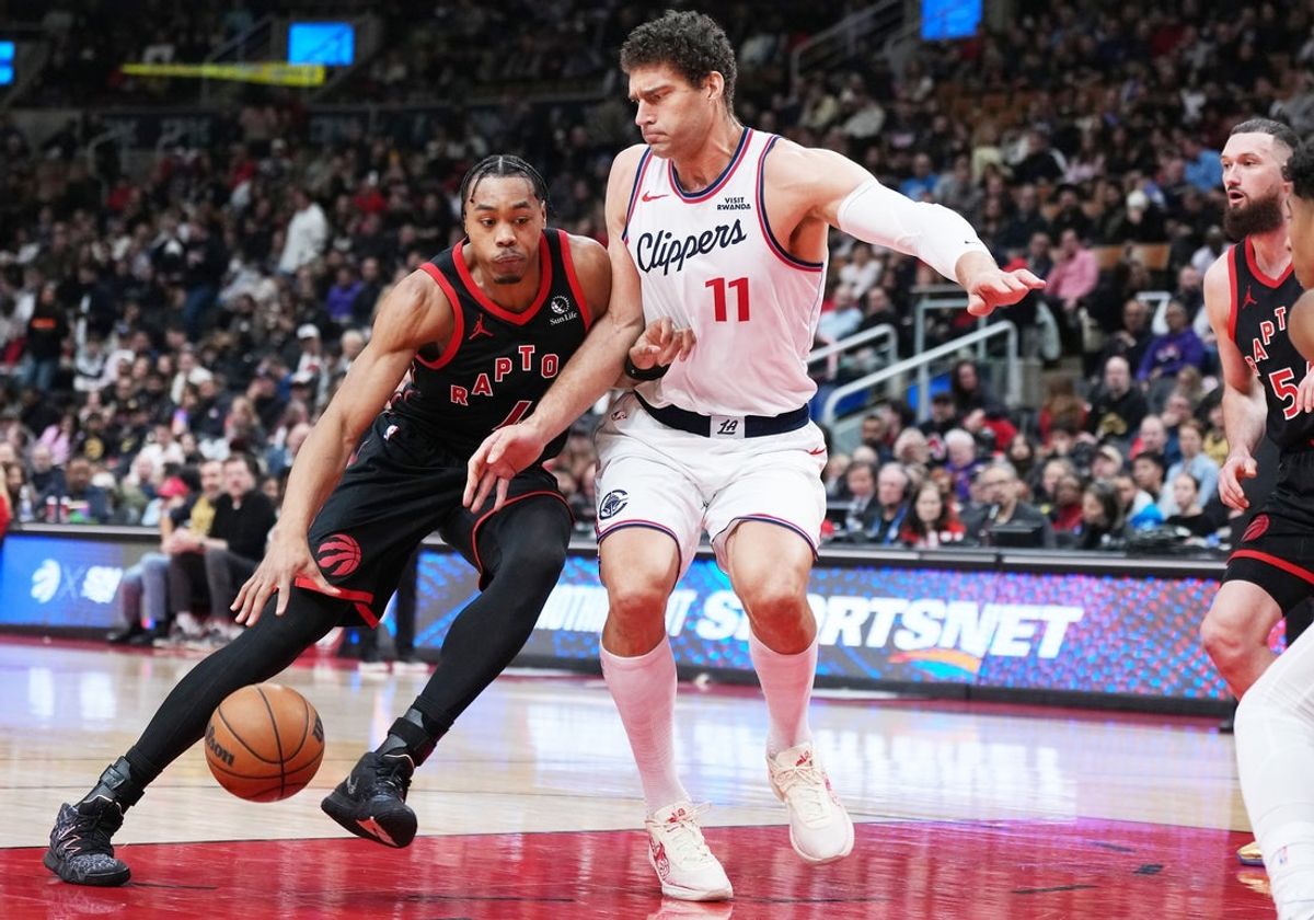 Jan 16, 2026; Toronto, Ontario, CAN; Toronto Raptors forward Scottie Barnes (4) drives to the basket as LA Clippers center Brook Lopez (11) tries to defend during the second quarter at Scotiabank Arena. Mandatory Credit: Nick Turchiaro-Imagn Images