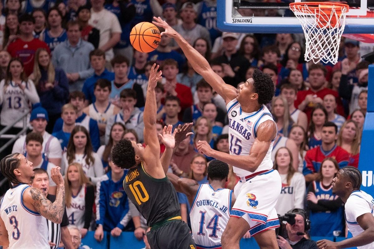 Kansas Jayhawks forward Bryson Tiller (15) blocks a shot by Baylor Bears guard Isaac Williams (10) during the game inside Allen Fieldhouse on Jan. 16, 2026.