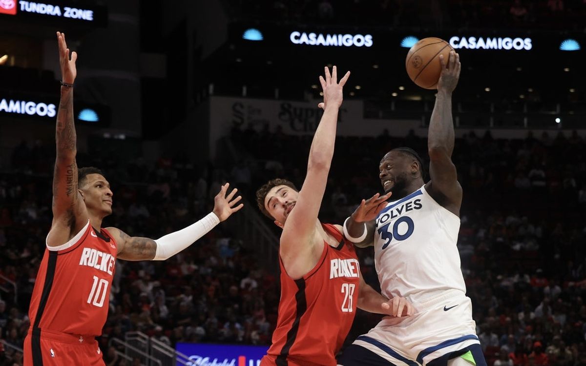 Jan 16, 2026; Houston, Texas, USA; Minnesota Timberwolves forward Julius Randle (30) passes against Houston Rockets center Alperen Sengun (28) and forward Jabari Smith Jr. (10) in the first quarter at Toyota Center. Mandatory Credit: Thomas Shea-Imagn Images